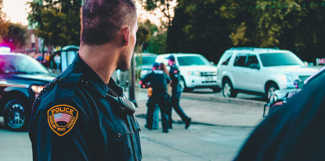 Police officers witnessing the arrest of an individual for drug-impaired driving.